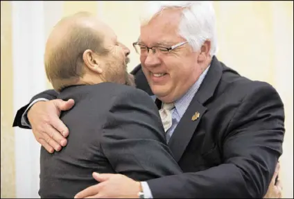  ?? PHOTOS BY PHIL SKINNER / SPECIAL ?? Outgoing Cobb Chairman Tim Lee (right) hugged long-time friend Jamie Vann after choking up during his speech at the Kiwanis Club of Marietta.