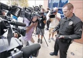  ?? Al Seib Los Angeles Times ?? AN LAPD OFFICER shows a body camera in 2015. The Police Commission is asking residents for input on when video from such devices should be released.