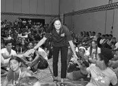  ?? COURTESY OF NBAE ?? Jennifer Azzi, a former WNBA player, greets players during a health workshop Tuesday.