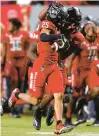  ?? LANCE KING/GETTY ?? Brandon Cisse (25) of North Carolina State celebrates his game-ending intercepti­on Saturday night against Miami.