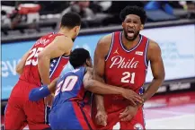  ?? CARLOS OSORIO — THE ASSOCIATED PRESS ?? Sixers center Joel Embiid (21) grimaces after Pistons guard Josh Jackson (20) ran into him while chasing guard Ben Simmons (25) during the first half Saturday in Detroit.