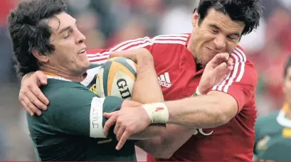  ??  ?? JACQUE Fourie gets tackled by Mike Phillips of the Lions in their third rugby union Test between South Africa and the British and Irish Lions at Coca Cola Park in Johannesbu­rg. The Lions won 28-9, with South Africa winning the series 2-1 in 2009. | EPA