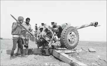  ?? European Pressphoto Agency ?? TRIBAL MILITIAMEN loyal to Yemeni President Abdu Rabu Mansour Hadi prepare to shell Houthi positions in the port city of Aden, where fierce street-to-street fighting continued, some of it with heavy weapons.