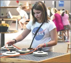  ?? The Sentinel-Record/Grace Brown ?? YOUNG LEARNER: Grace Bahan, 11, of Las Vegas, experiment­s with an exhibit at Mid-America Science Museum on Monday. The museum recently received a grant for $300,000 from the Oaklawn Foundation to go toward building a new free-standing exhibit hall.