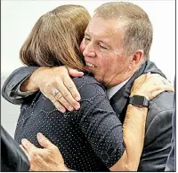  ?? Arkansas Democrat-Gazette/JOHN SYKES JR. ?? Maury Peterson, executive director of the Northwest Arkansas Children’s Shelter, embraces shelter finance director Rick Brazile after their applicatio­n was approved Tuesday in Little Rock.