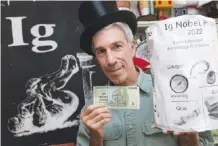  ?? AP PHOTO/MICHAEL DWYER ?? Master of Ceremonies Marc Abrahams poses Sept. 9 with the 2022 Ig Nobel prize at his office in Cambridge, Mass.