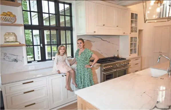  ?? NICOLAS GALINDO/THE COLUMBUS DISPATCH ?? Maryalliso­n Comfort and her daughter Cecilia, 5, in the family’s recently remodeled kitchen. “I’m in here all the time,” Comfort said. “This is the heart of the home.”