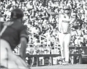  ??  ?? ABOVE: Arkansas junior pitcher Isaiah Campbell tries a pick-off attempt in a 1-0 loss to Florida State Saturday in Omaha, Nebraska. Campbell pitched seven scoreless innings, but the usually potent Razorbacks offense couldn’t score. The Hogs play Texas Tech today at 1 p.m.