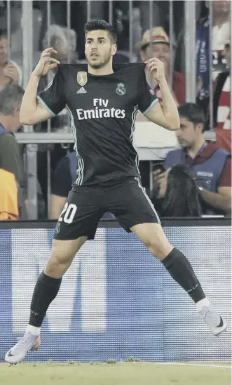  ??  ?? Real Madrid’s Marco Asensio celebrates scoring his side’s second goal against Bayern.