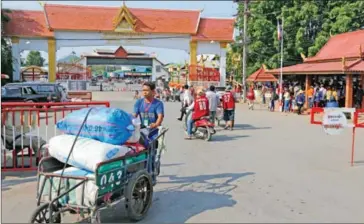  ?? HENG CHIVOAN ?? A porter pushes goods across the Thai-Cambodian border in Battambang in April.