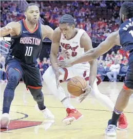  ?? MICHAEL WYKE/AP ?? Heat forward Josh Richardson has the ball knocked away between Rockets guards Eric Gordon (10) and James Harden during the first half of Monday’s game.