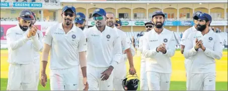  ?? AP ?? Teammates applaud Jasprit Bumrah, who played a stellar role with a fivewicket haul that helped India win the third Test versus England at Nottingham.