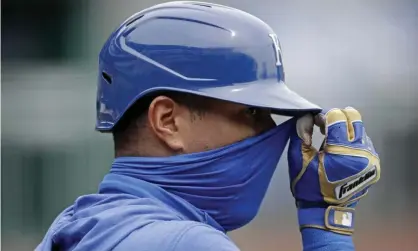  ?? Photograph: Charlie Riedel/AP ?? The Kansas City Royals’ Salvador Perez adjusts his mask during batting practice. He tested positive for Covid-19 earlier this summer.