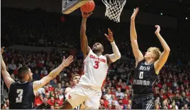  ?? DAVID JABLONSKI / STAFF ?? Dayton’s Trey Landers scores two of his 15 points in the opener against North Florida on Wednesday. Landers also tied for the team high with 10 rebounds.