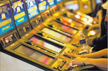  ?? CHASE STEVENS/ LAS VEGAS REVIEW-JOURNAL ?? People play on slot machines at Main Street Station in downtown Las Vegas. The Internal Revenue Service has proposed lowering the reporting level for gambling winnings from $1,200 to $600, a move that the casino industry and its patrons oppose.