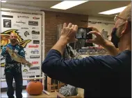  ?? RICHARD PAYERCHIN — THE MORNING JOURNAL ?? Nick Lary of West Middlesex, Pa., holds up his walleye weighed Nov. 10 for the Fall Brawl fishing tournament as Mike Chaffin, right, clerk and chief helper at Erie Outfitters bait and tackle shop, snaps a photo.