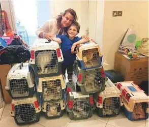  ??  ?? Nicoletta Via and her son, Emanuele, with the 10 cats that were relocated.