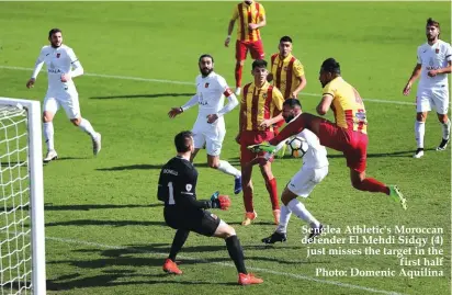  ??  ?? Senglea Athletic's Moroccan defender El Mehdi Sidqy (4) just misses the target in the first half Photo: Domenic Aquilina