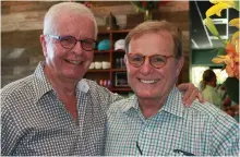  ??  ?? TOTI Media founder/chairman Friedrich Jaeger (left) congratula­tes Marty Harrity at the September opening of the new Sanibel Doc Ford's. Outdoor dining is a popular option (right) at each of the three locations.