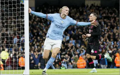  ?? RICHARD SELLERS — PA VIA AP ?? Manchester City’s Erling Haaland celebrates scoring his side’s first goal in the FA Cup quarterfin­als on Saturday.