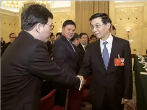  ?? WANG YE / XINHUA ?? Wang Huning (right) meets with the Hong Kong delegation to the National People’s Congress during the annual two sessions in Beijing.