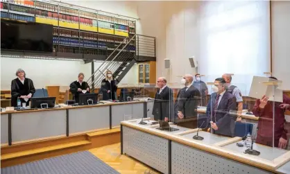  ??  ?? Defendant Eyad al-Gharib (hidden behind a folder) in a courtroom in Koblenz, western Germany. He has been convicted of crimes against humanity in the first trial of its kind to emerge from the Syrian conflict. Photograph: Thomas Lohnes/AFP/Getty Images