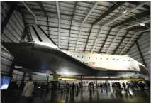  ?? PHOTO BY GENE BLEVINS ?? People get a last chance to see the space shuttle Endeavour on display at the California Science Center in Los Angeles before the exhibit closed down on Dec 31. Endeavour began a move Friday and will be positioned in the Air and Space Center, which will then be completed in the full shuttle stack position.