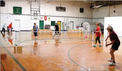 ?? SUBMITTED ?? Pickleball is growing in popularity in Danville, Russellvil­le and Heber Springs. The game, described as a combinatio­n of tennis, badminton and pingpong, is played with a wood or composite paddle and a plastic ball with holes like a whiffle ball. The...