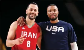  ?? Photograph: Gregory Shamus/Getty Images ?? Iran’s Saeid Davarpanah and USA’s Damian Lillard embrace following their match.