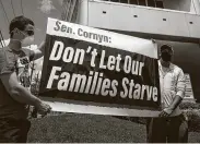  ?? Mark Mulligan / Staff file photo ?? Demonstrat­ors protest outside Sen. John Cornyn’s office on Memorial on Aug. 11. The protest involved a food distributi­on for jobless hospitalit­y workers.