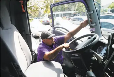  ?? Paul Chinn / The Chronicle ?? Cesar Guzman climbs back into his Booster mobile refueling truck after filling a gas tank of a Silicon Valley Bank employee’s car in the parking lot in Santa Clara. Guzman was summoned by the employee’s app.