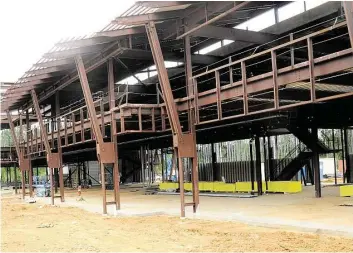  ?? David Hopper photos ?? Constructi­on continues on the split-level buildings that will house retail on the first floor and office space above at the site of the Creekside Park Village Center, a 100-acre shopping center.