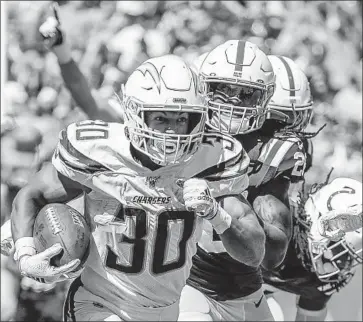  ?? Robert Gauthier Los Angeles Times ?? THE CHARGERS’ Austin Ekeler races past the Colts’ defense on a 55-yard touchdown reception during the third quarter. Ekeler and fellow running back Justin Jackson excelled in filling in for holdout Melvin Gordon.