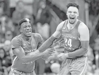  ?? Charlie Riedel / Associated Press ?? Oregon guard Dylan Ennis, left, celebrates with teammate Dillon Brooks at the end of the Midwest Regional final against Kansas in the NCAA Tournament on Saturday in Kansas City, Mo.