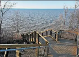  ?? CAROL HARPER — THE NEWS-HERALD ?? Steps lead to a sandy beach and an evening reverie in April at Lake Erie Bluffs, a Lake County Metroparks at 3301 Lane Road in Perry Township.