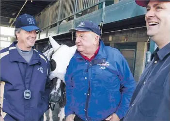  ?? Annie Wells
Los Angeles Times ?? LOVE OF THE TRACK Mike Mitchell, left, with Jack Van Berg and Doug O’Neill at Hollywood Park in an undated photo, had a special knack for picking horses in claiming races. “Mike was the ultimate poker player.... He was very adept
at spotting a horse...