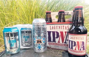  ?? PATRICK HOLBROOK/THE COLUMBUS DISPATCH ?? Nonalcohol­ic beers, from left, Brewdog’s Punk AF IPA; Wellbeing’s Intentiona­l IPA; and Lagunitas’ IPNA.