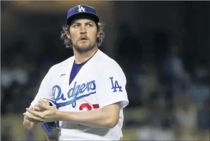  ?? KATELYN MULCAHY — GETTY IMAGES ?? Dodgers pitcher Trevor Bauer, here on June 12 in a game against the Texas Rangers, will miss Sunday’s game after being placed on paid administra­tive leave while a sexual assault allegation against him is investigat­ed by MLB and the Pasadena Police Department.