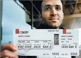  ?? ANTONIO CALANNI/AP ?? Iranian-born Nima Enayati happily shows his boarding pass Sunday in Milan, Italy.