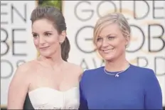  ?? John Shearer / Invision / AP ?? Tina Fey, left, and Amy Poehler arrive for the 2015 Golden Globe Awards in Beverly Hills, Calif. The Globes announced next year’s show will be held Feb. 28, the date for which the Oscars were previously scheduled.