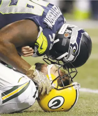  ?? STEPHEN BRASHEAR/THE ASSOCIATED PRESS ?? Seahawks defensive end Quinton Jefferson sacks Aaron Rodgers Thursday during Green Bay’s 27-24 loss.