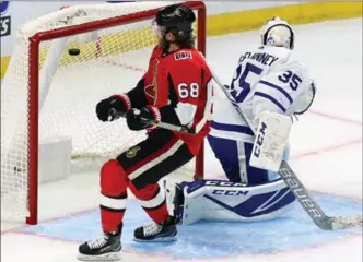  ?? FRED CHARTRAND, THE CANADIAN PRESS ?? Senators’ Mike Hoffman (68) scores past Toronto Maple Leafs goalie Curtis McElhinney in the first period of a National Hockey League pre-sesaon game in Ottawa on Monday. For the result, see therecord.com.