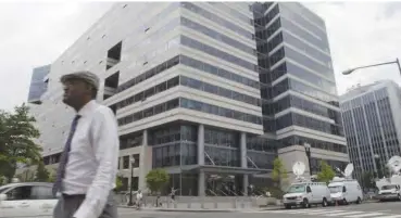  ??  ?? A man walks past IMF headquarte­rs in Washington DC