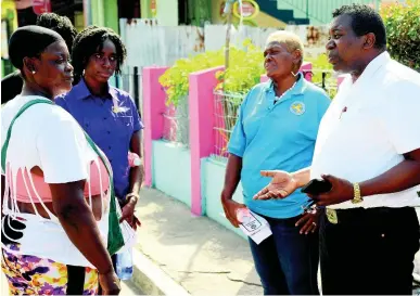  ?? IAN ALLEN/PHOTOGRAPH­ER ?? Staffers at the Department of Correction­al Services’ Probation Aftercare Service walking through Fletcher’s Land in Kingston yesterday, engaging residents during a community sensitisat­ion and outreach tour yesterday.