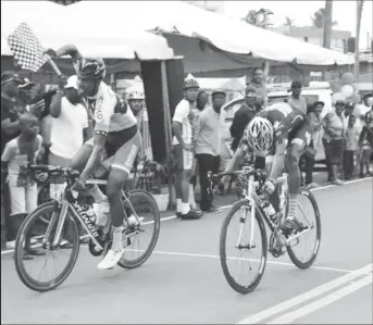  ??  ?? Team Coco’s Jamal John held off a fast finishing Curtis Dey (Trojan PSL) to claim the Indian Arrival Day 60-mile road race in thrilling fashion yesterday in New Amsterdam. (Orlando Charles photo)