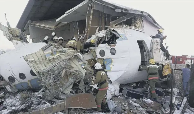  ??  ?? 0 Rescue workers search the Bek Air plane for survivors after it crashed near Almaty Internatio­nal Airport in Kazakhstan