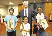  ?? Pearland ISD ?? Pearland Independen­t School District Superinten­dent John Kelly congratula­tes spelling bee winners Siddharth Krishnakum­ar, left, Wende Wang and Zoe Navy.