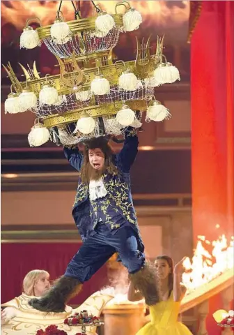  ?? Kevork Djansezian Getty Images ?? HOST ADAM DEVINE gets in the swing of things during the MTV Movie & TV Awards on Sunday.