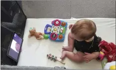  ?? COURTESY OF JULIE BUFKIN ?? Julie Bufkin’s 7-month-old boy, Calvin, interacts with his grandmothe­r Debbie Cameron, in Chandler, Ariz., on a FaceTime call from his crib in Tempe, Ariz.