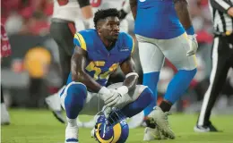  ?? PETER JONELEIT/AP ?? Rams linebacker Leonard Floyd looks at the video board during a 2022 game against the Buccaneers.